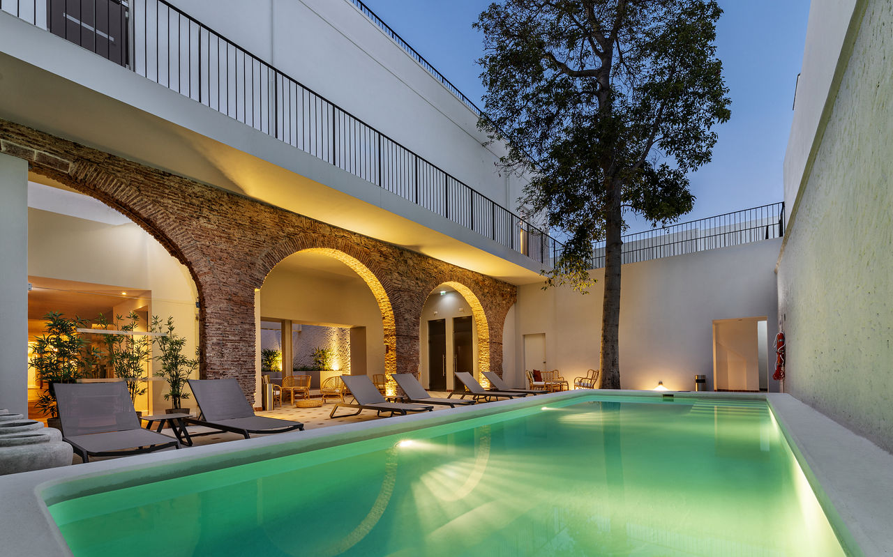 Illuminated outdoor pool of Pousada Vila Real de Santo António, a charming hotel in Vila Real de Santo António