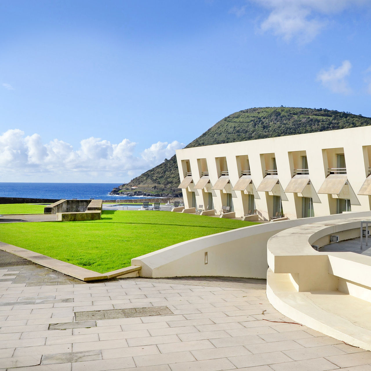 Windows of the Pousada rooms with gardens and pool in the background and sea view