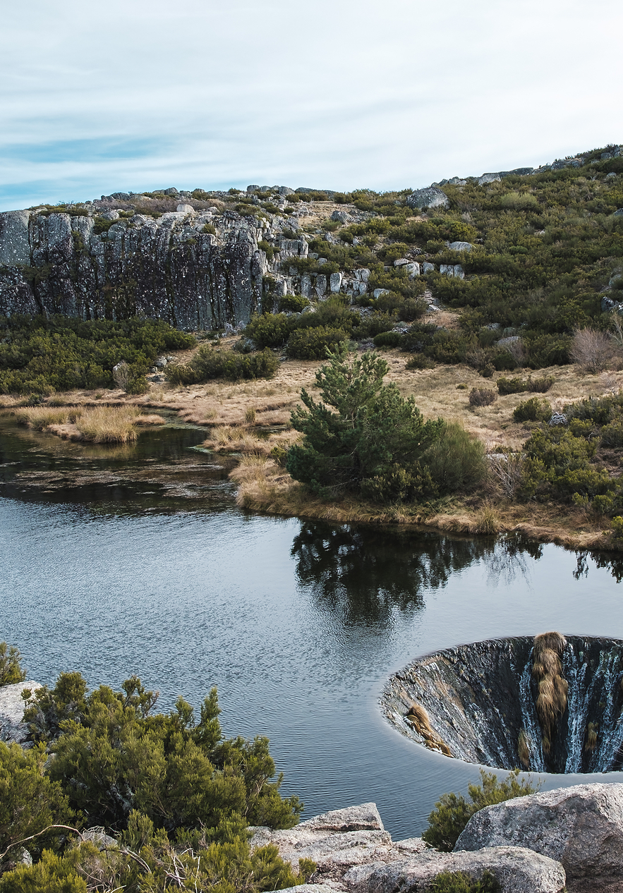 Covão dos Conchos a lagoon in Serra da Estrela with low vegetation around and a mysterious hole in the lagoon