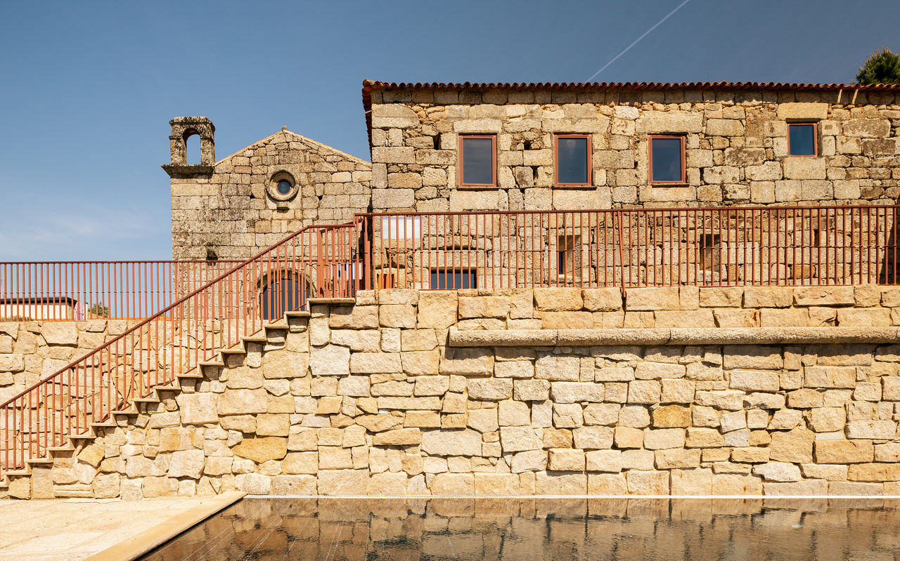 Exterior of Pousada Convento de Belmonte in stone, with stairs, in the historic center of Belmonte in central Portugal