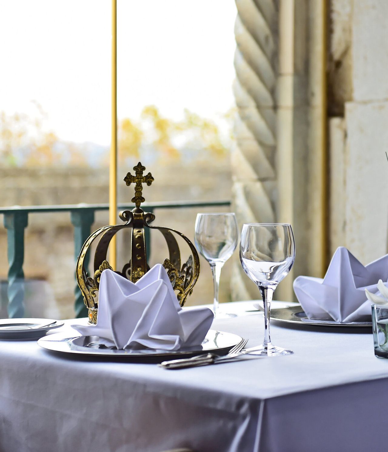 The Pousada Castelo Óbidos restaurant, of the Charming Hotel in the Medieval Village of Óbidos, has a set table with a crown