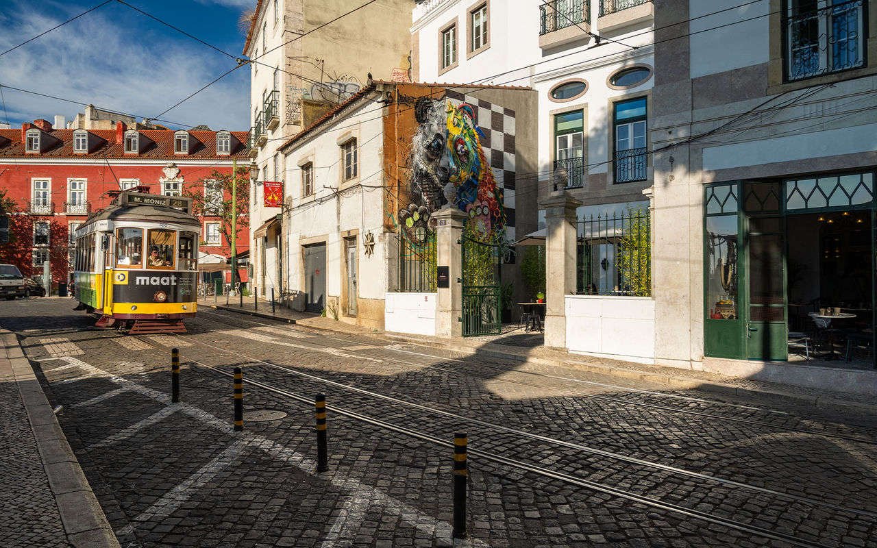 Entrance of the Pousada de Alfama in the historic center of Lisbon with tram 28 passing by