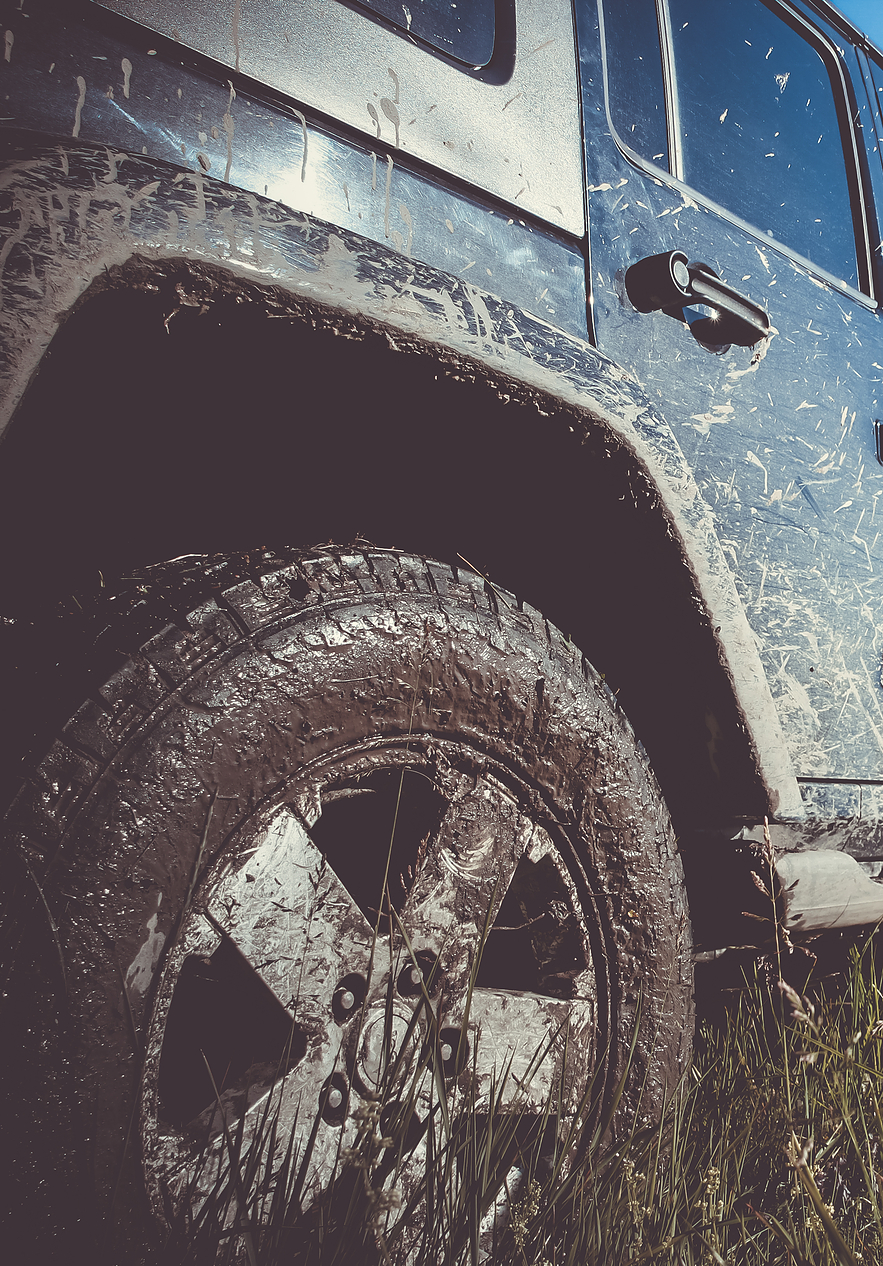 Tire of a jeep covered in mud on a tour of Peneda-Gerês National Park