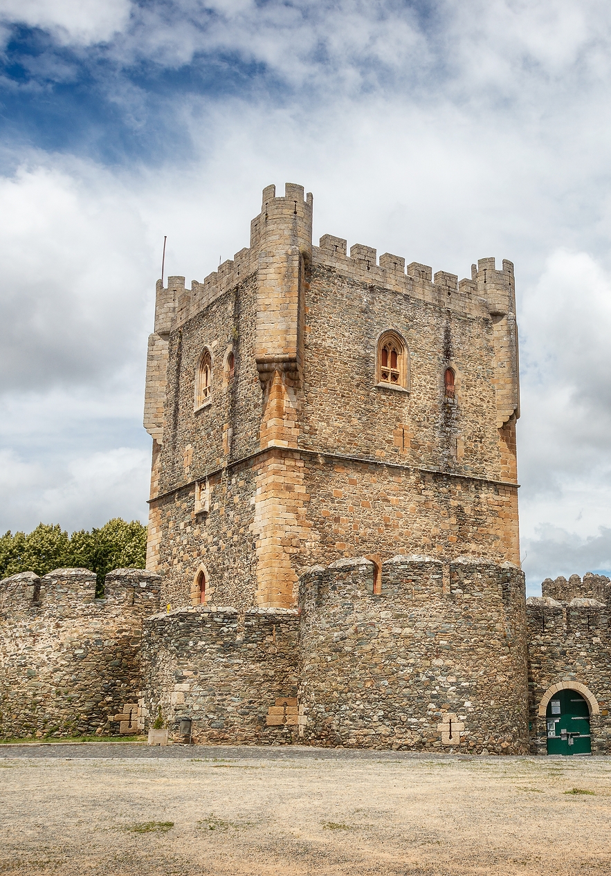 Medieval tower of Bragança Castle a stone structure surrounded by a circular wall of rustic stones