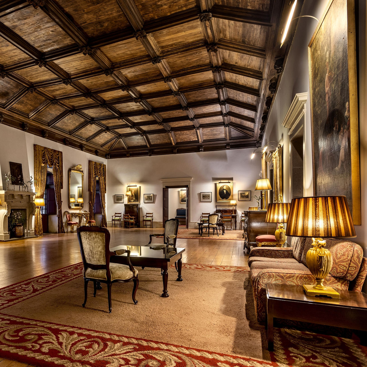Interior of Pousada Mosteiro Guimarães, a hotel in the historic center of Guimarães, with a wooden ceiling and several sofas