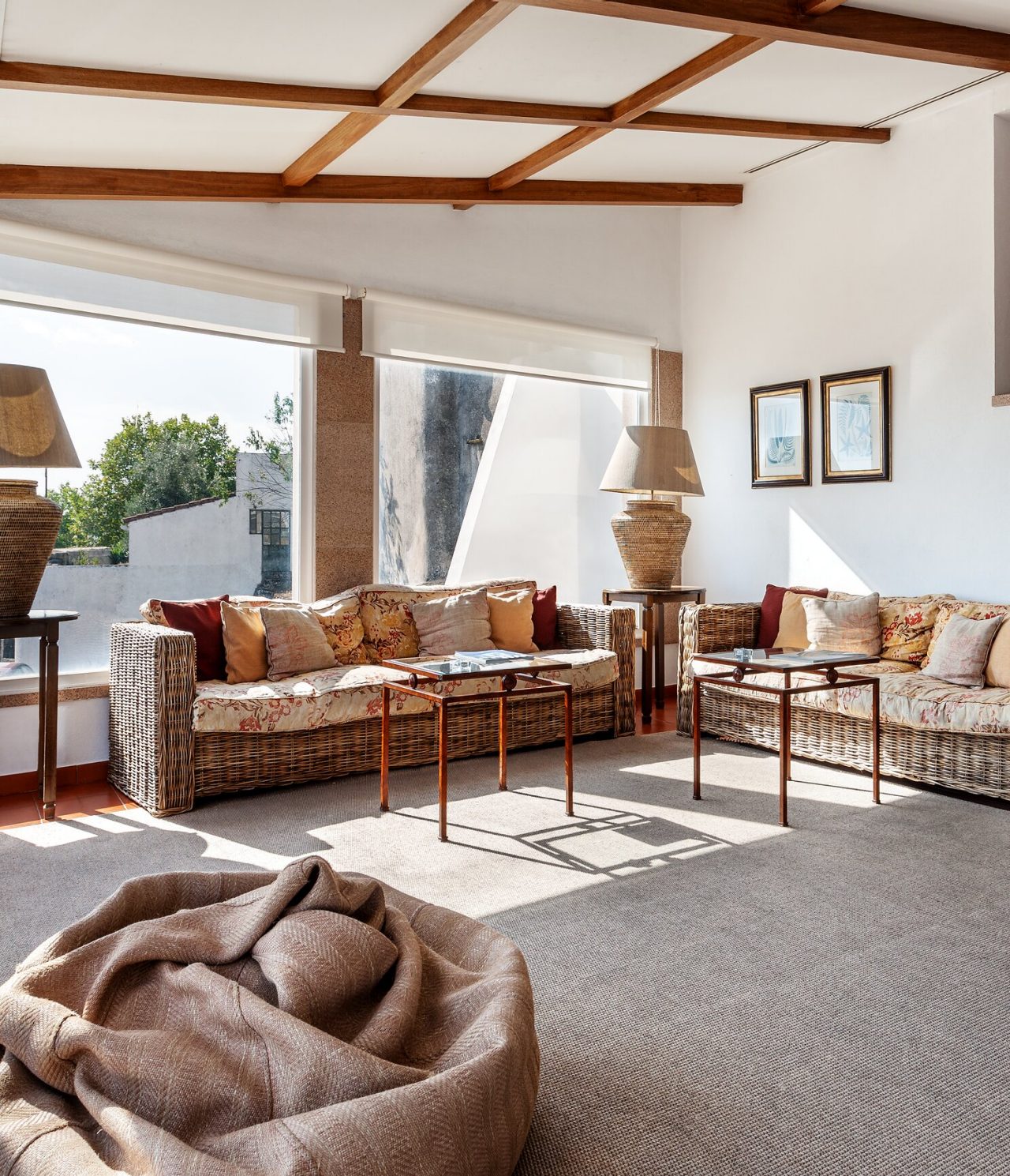 The bar of the Historic Hotel in Marvão has several sofas, armchairs, and large windows