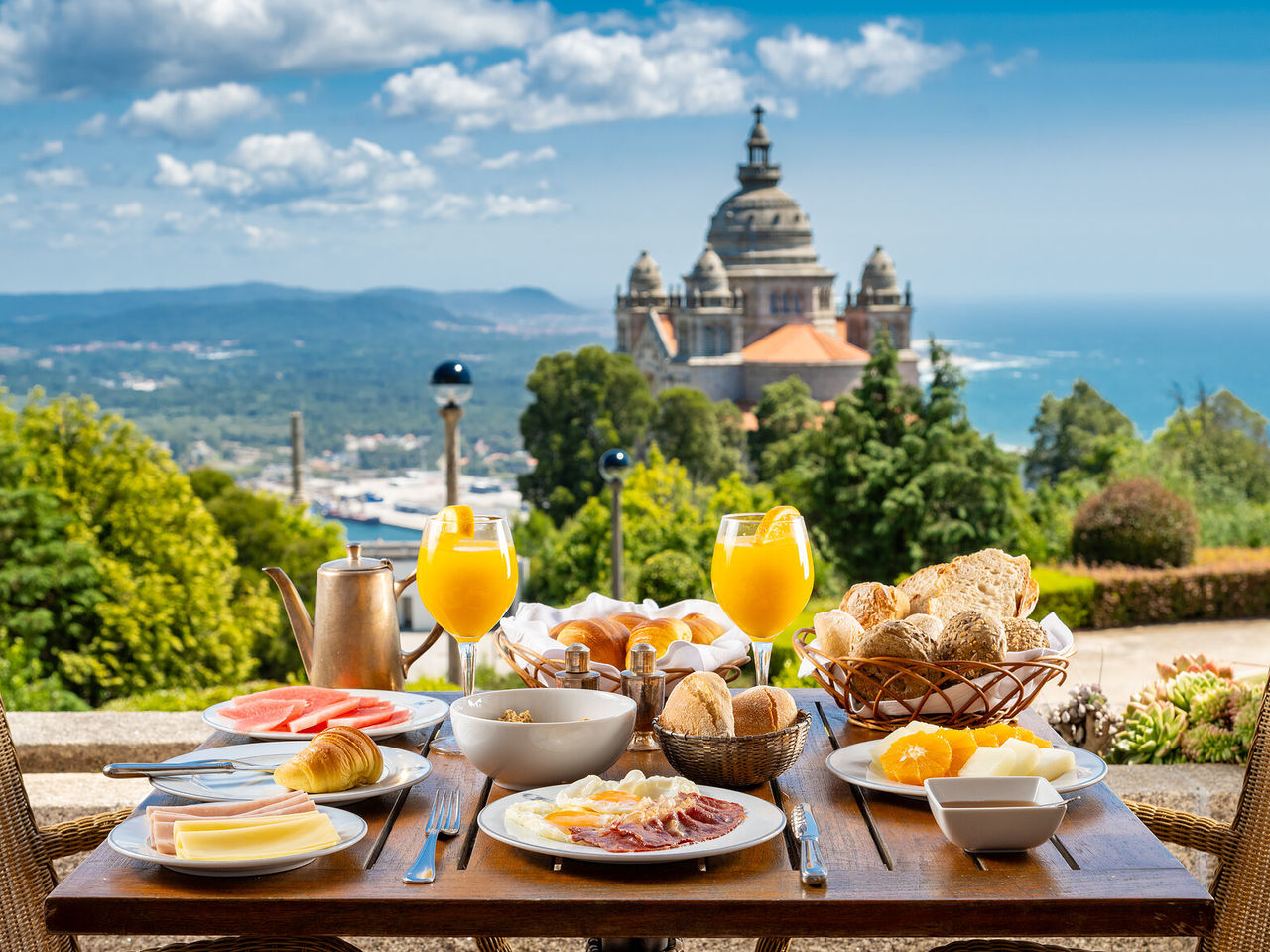 The restaurant of the Historic Hotel in Viana do Castelo serves breakfast at a table with a view of the Basilica
